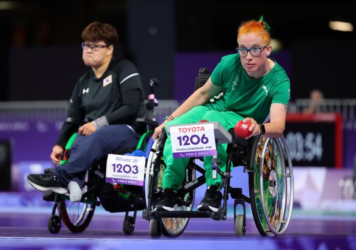 Two female boccia athletes are in competition.